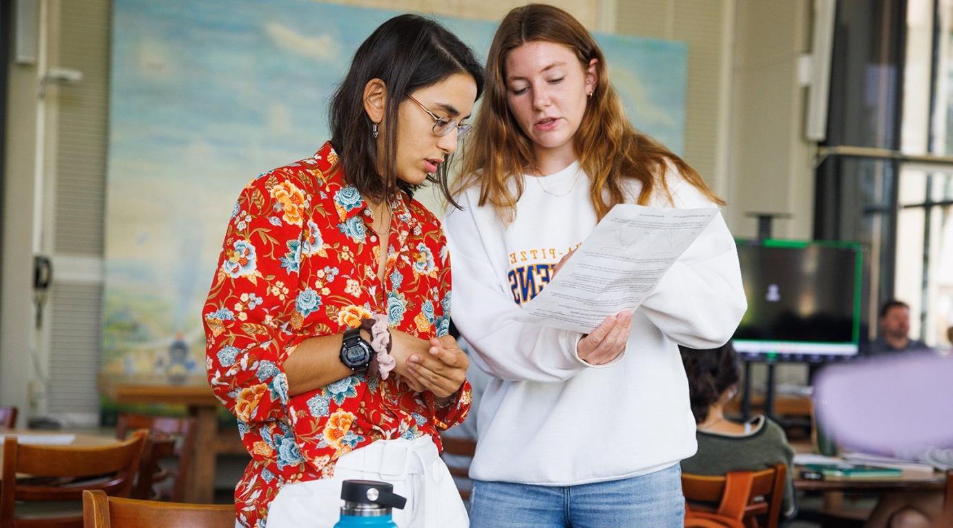 two students look over a paper