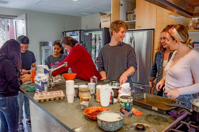 students cook in the demonstration kitchen during a first year seminar